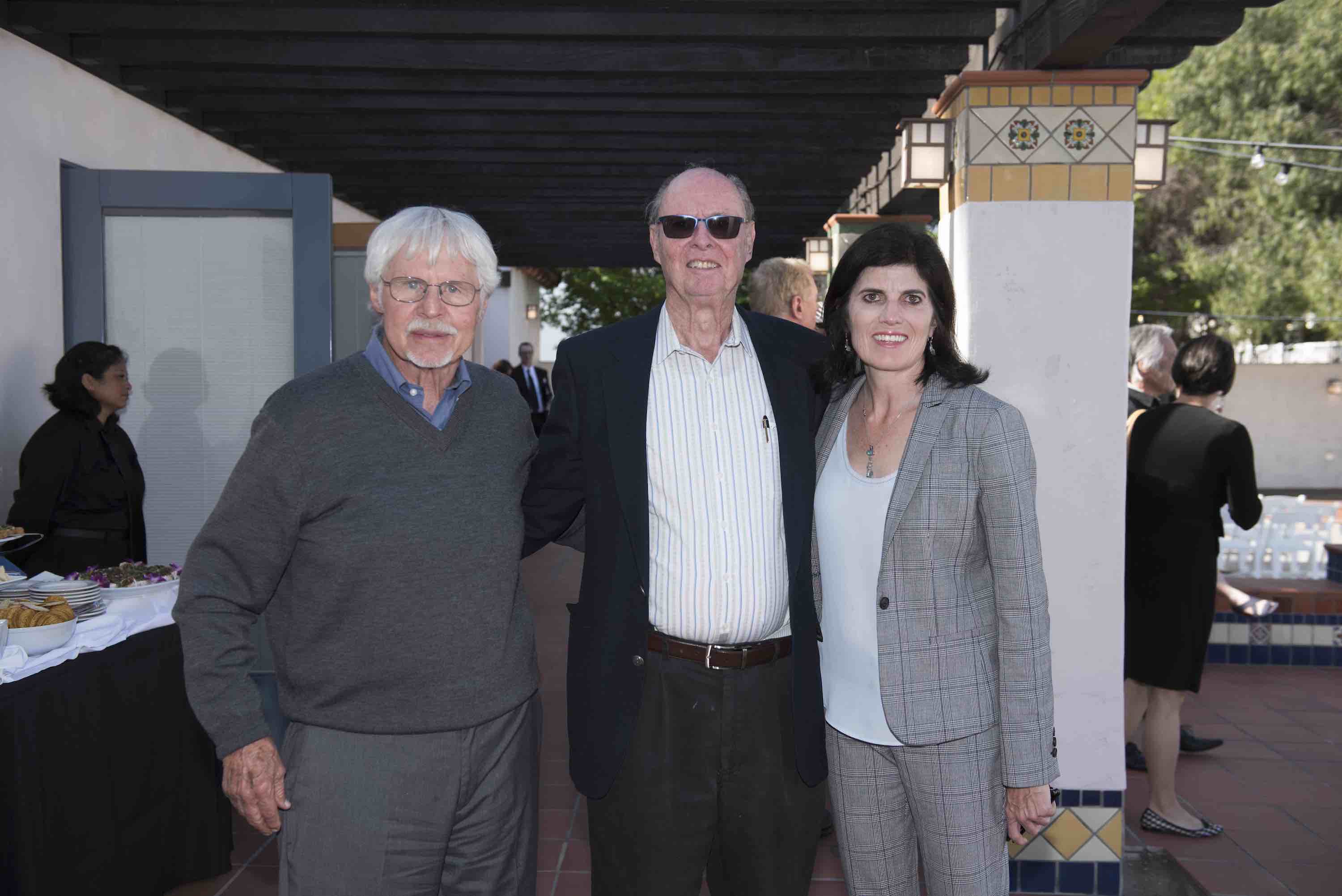 Dr. Hansen, Dr. de Graaf, and Dr. Fousekis stand side by side in exterior courtyard at COPH's 50th anniversary event