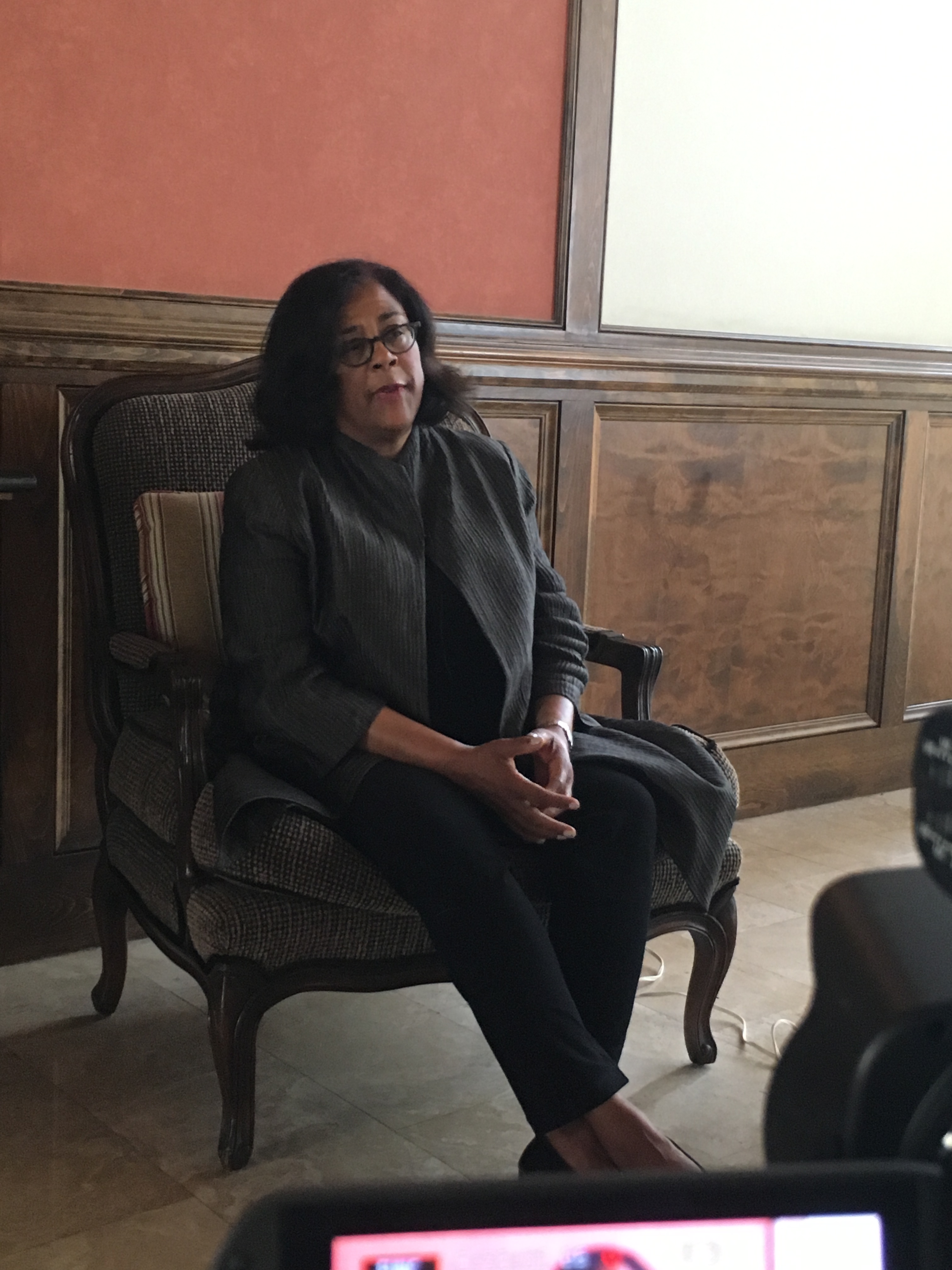 Jan Perry sitting in chair speaking