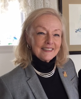 Sue Savary smiling in grey suit