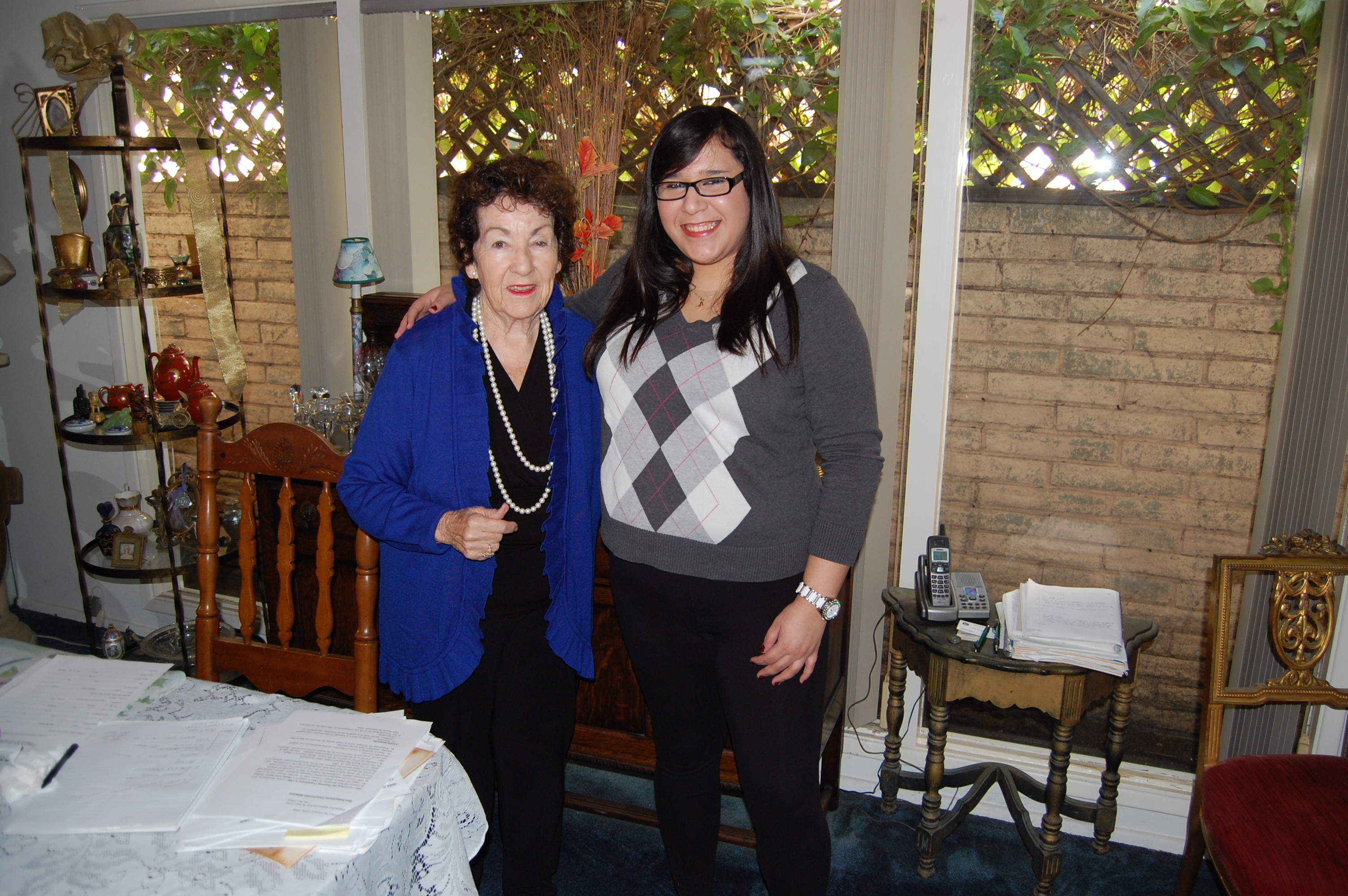Ursula Kennedy stands with Natalie Navar in dining room