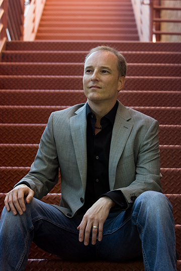 Benjamin Cawthra seated on red staircase